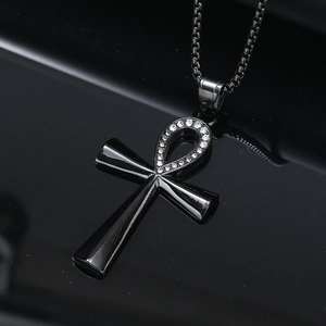 Macro shot of black plated Ankh pendant with rhinestones and box chain details