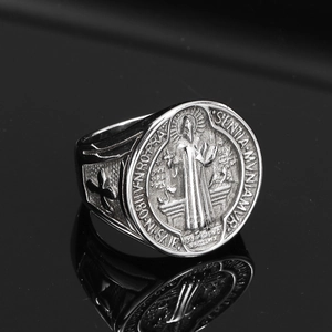 Detailed macro view of retro Saint Benedict medal engraving on stainless steel hip hop ring