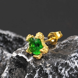 Luxuriöser Drachenkrallen-Ohrstecker mit grünem Edelstein und Goldbeschichtung auf Stein