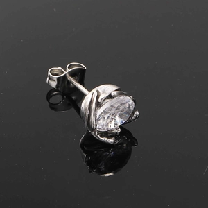 Detailed close-up of a silver titanium steel stud earring with a round-cut zircon stone