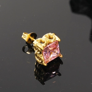 Dettaglio orecchino con zircone rosa quadrato e finitura dorata con motivi vintage