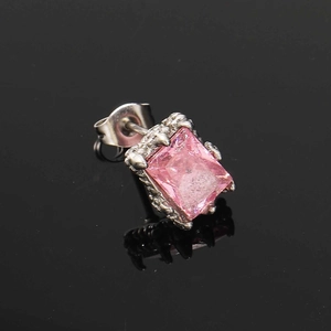 Detail eines quadratischen rosa Zirkon-Ohrrings mit silberner Krallenfassung auf Schwarz