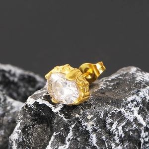 Golden titanium steel oval earring with a large sparkling zircon in a vintage crown setting