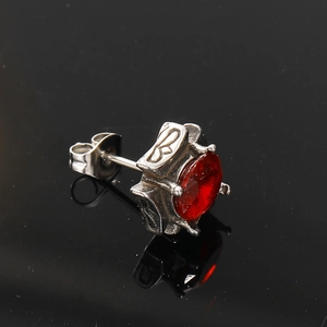Macro view of vintage style titanium steel stud earring with a square red zircon stone