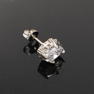 Detail of four-prong set oval zircon stud earring in polished titanium steel