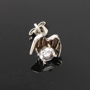 Punk vintage silver wing claw stud earring with zircon stone on black reflective surface