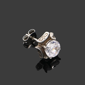 Macro detail of gothic square zircon stud earring with vintage cross engraving and silver finish