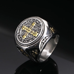 Nahaufnahme des St. Benedikt Rings mit Goldkreuz-Gravur auf dem silbernen Stahlband