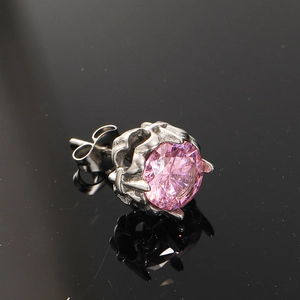 Vintage stainless steel stud earring with pink zircon and crown setting on black surface