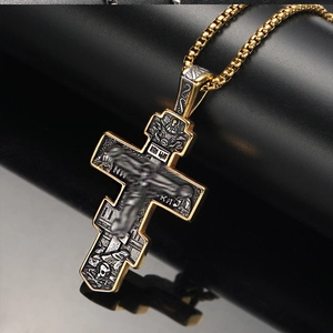 Detail showing Orthodox cross pendant with Jesus relief and vintage box chain on black base