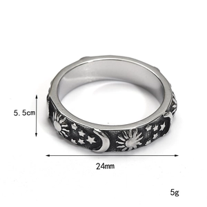 Vintage stainless steel sun and moon ring with celestial embossed patterns on white background