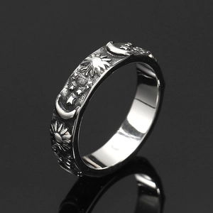 Detailed macro view of vintage sun, moon, and stars embossed on a retro silver ring