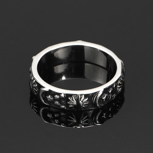 Vintage celestial stainless steel ring with sun and moon relief on black mirror surface