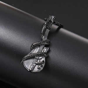 Macro detail of punk rock stainless steel snake wrapped around a guitar pendant