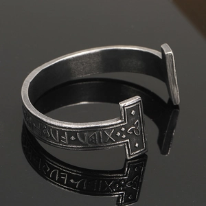Macro shot of vintage Viking bangle with Nordic Runes and Celtic knot engravings