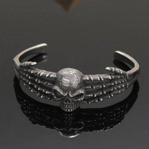 Detailed close-up of a vintage Viking skull bangle in a dark retro silver finish