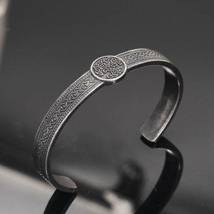 Macro detail of Nordic Viking bangle showing Celtic weave pattern and Tree of Life totem
