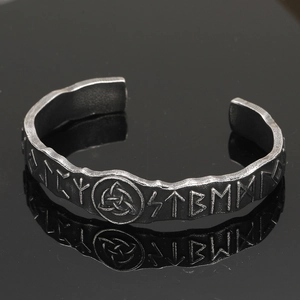 Detailed close-up of retro Viking cuff bracelet with Nordic runes and Celtic knots
