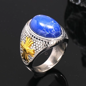 Close-up of vintage titanium steel ring with blue gemstone and gold floral relief