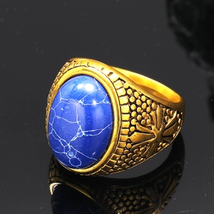 Macro view of vintage gold-plated titanium ring with large oval blue gemstone inlay