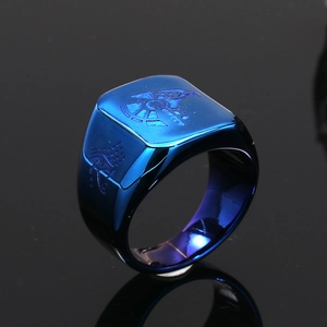 Detailed macro view of blue stainless steel ring with Horus Eye and falcon engraving