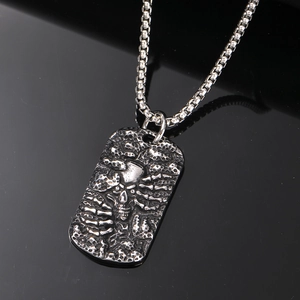 Retro punk rectangular skeleton pendant with steel chain shown against a black reflection