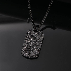 Macro shot of black punk skull steel pendant with textured metallic finish and square link chain