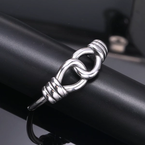 Polished silver stainless steel open bangle with intricate intertwined knot design for unisex