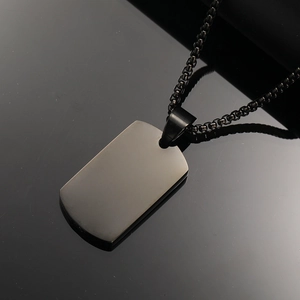 Macro shot of matte gunmetal stainless steel military tag pendant on box chain
