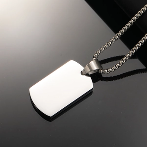 Minimalist stainless steel urn necklace with polished military dog tag pendant on black background