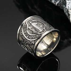Macro shot of vintage silver Saint Benedict exorcism medal ring in punk titanium steel style