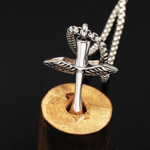 Feather cross stainless steel cremation necklace with silver wing urn pendant on wood base
