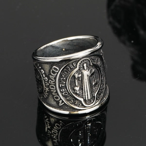 Close-up of vintage Saint Benedict ring with retro silver finish and holy medal engraving