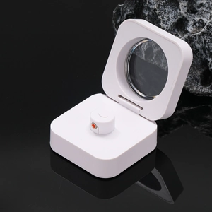 Macro detail of portable square white folding loupe with red accent on black surface