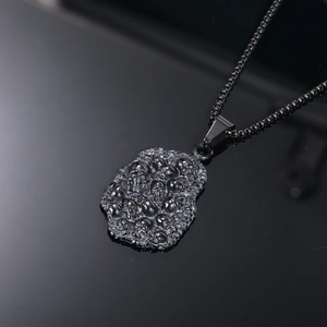 Macro detail of gothic skull pendant with 3D relief on gunmetal vintage necklace