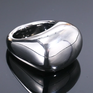 Macro shot showing the high-polished silver mirror surface of the minimalist steel ring