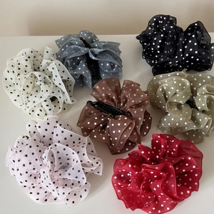 Detail of large mesh polka dot banana hair clips in seven diverse elegant colors