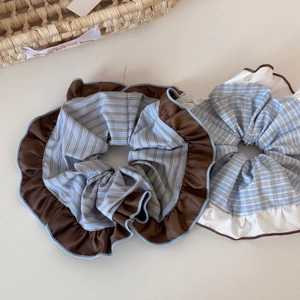 Detail of oversized striped and checkered scrunchies with elegant lace trim texture