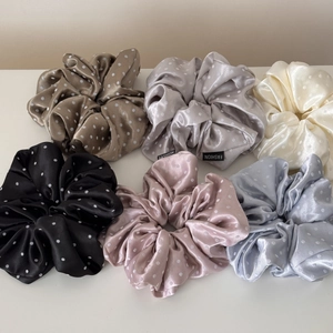 Detail view of 6-piece polka dot satin scrunchies in assorted soft colors set