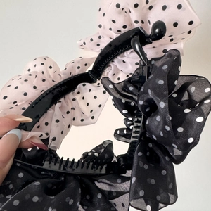Detailed close-up of French style polka dot chiffon bow banana hair clip for women