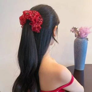 French elegant red organza polka dot hair scrunchie shown on a woman ponytail