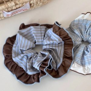 Oversized coffee and blue contrast ruffle scrunchies with stripes on cream background