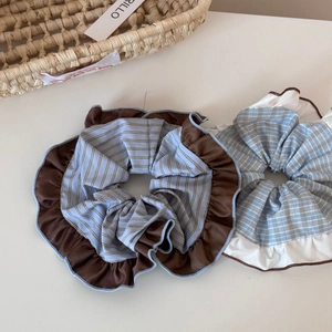 Detail of coffee brown and blue striped scrunchies with elegant ruffled lace edges