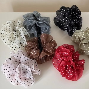 Close-up of assorted polka dot mesh hair clips in seven elegant pastel colors