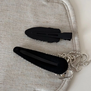 Detail of black rhinestone tassel hair clips with sparkling silver crystal fringe accents