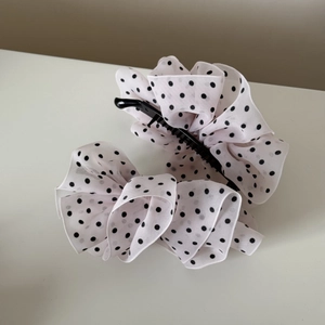 Detailed close-up of French style chiffon polka dot hair clip with elegant layered ruffles