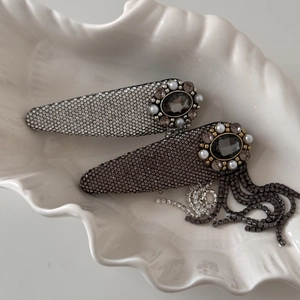 Detail view of vintage hair clips with rhinestones, pearls and elegant tassels