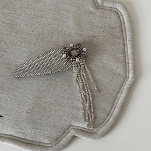 Detail of luxury rhinestone hair clip with pearls and elegant tassel pendants