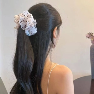 French elegant white chiffon polka dot hair scrunchie shown on a ponytail hairstyle