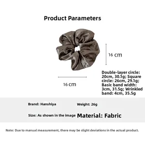 Detailed view of dark taupe satin polka dot scrunchie with 16cm dimensions and weight info